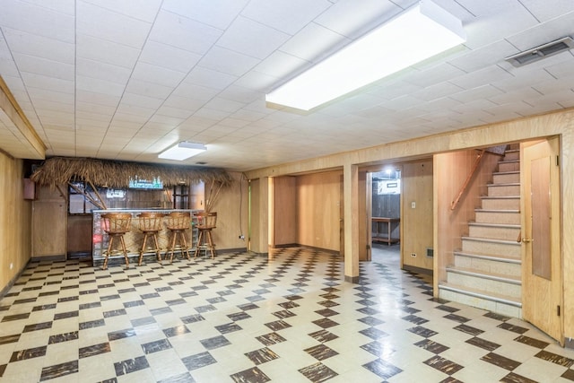 1919 Sunnyside Ave, Westchester, IL 60154 - finished below grade area with wood walls, tile patterned floors, a bar, and stairway