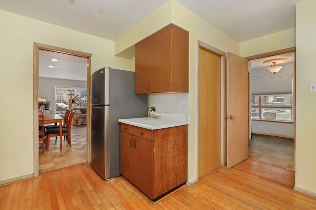 5770 N Forest Glen Ave, Chicago, IL 60646 - kitchen with plenty of natural light, light wood finished floors, light countertops, and freestanding refrigerator