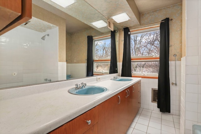 5770 N Forest Glen Ave, Chicago, IL 60646 - bathroom with tile patterned floors, double vanity, tile walls, and a sink