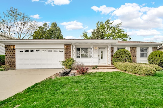 ranch-style home with brick siding, a garage, concrete driveway, and a front yard