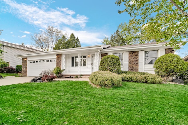 single story home with brick siding, a garage, and a front yard