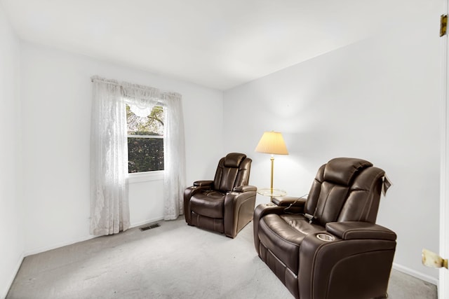living area featuring carpet floors and baseboards