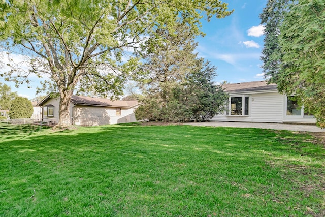 view of grassy yard featuring a patio area