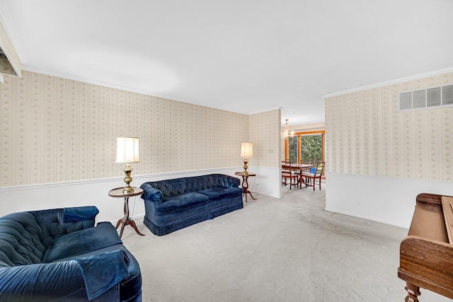 living area featuring a wainscoted wall, a chandelier, carpet flooring, crown molding, and wallpapered walls