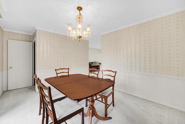 carpeted dining room with wallpapered walls, crown molding, a chandelier, and a wainscoted wall