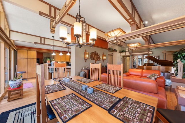 8712 W 121st St, Palos Park, IL 60464 - dining area featuring wood finished floors, a chandelier, and a towering ceiling