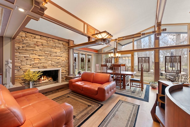 8712 W 121st St, Palos Park, IL 60464 - living area with a fireplace, plenty of natural light, a chandelier, wood finished floors, and high vaulted ceiling