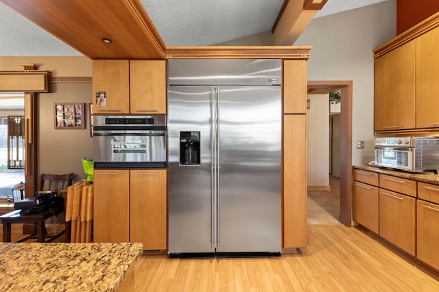 8712 W 121st St, Palos Park, IL 60464 - kitchen with appliances with stainless steel finishes, light wood finished floors, light stone countertops, and a textured ceiling