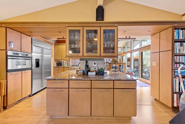 8712 W 121st St, Palos Park, IL 60464 - kitchen featuring stainless steel appliances, lofted ceiling, stone counters, light wood-style flooring, and glass insert cabinets