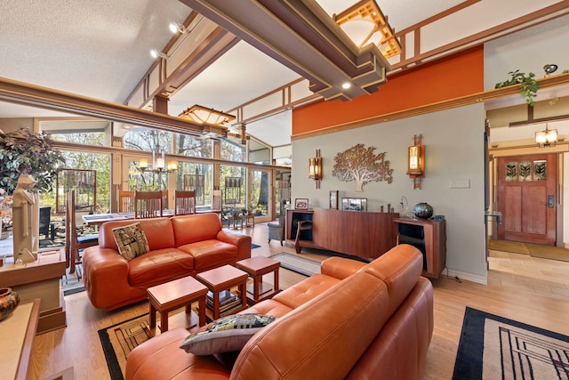 8712 W 121st St, Palos Park, IL 60464 - living area featuring a chandelier, a high ceiling, light wood-style flooring, and baseboards