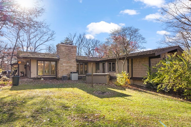 8712 W 121st St, Palos Park, IL 60464 - rear view of property featuring central air condition unit, a lawn, a chimney, and stucco siding