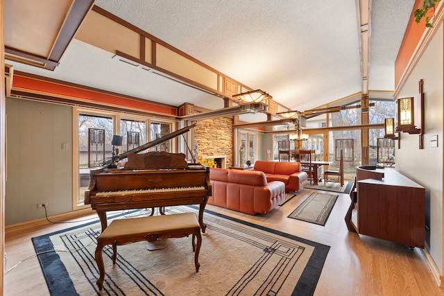 8712 W 121st St, Palos Park, IL 60464 - living area with wood finished floors, a textured ceiling, a stone fireplace, high vaulted ceiling, and beamed ceiling