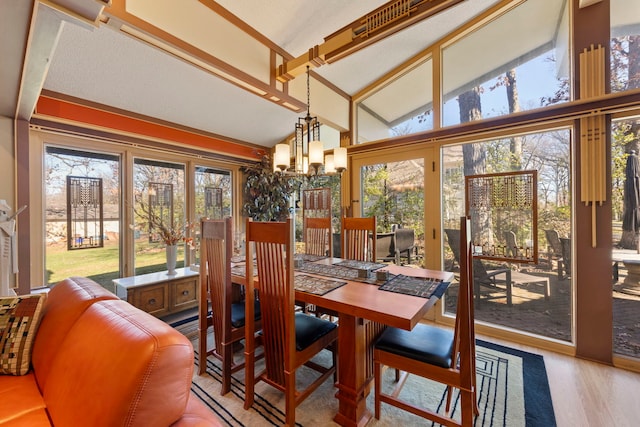 8712 W 121st St, Palos Park, IL 60464 - dining space with a chandelier, lofted ceiling, and wood finished floors