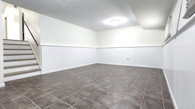 below grade area with stairway and baseboards