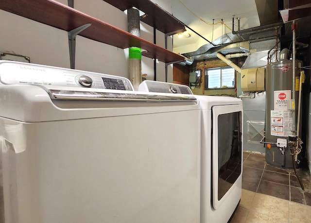 laundry room with water heater, tile patterned floors, washer and clothes dryer, and laundry area