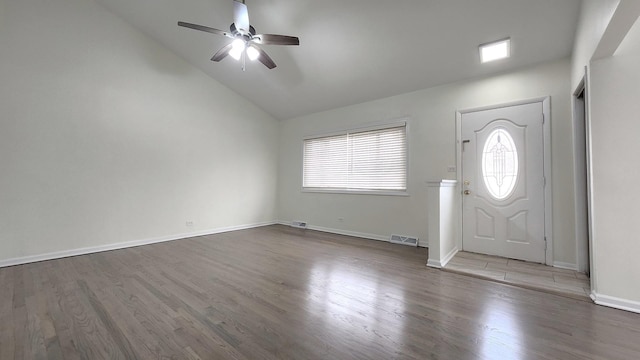 foyer with visible vents, baseboards, a ceiling fan, wood finished floors, and lofted ceiling