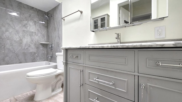 full bath with vanity, wood finished floors, toilet, and tub / shower combination