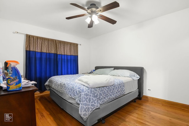 bedroom featuring wood finished floors and ceiling fan
