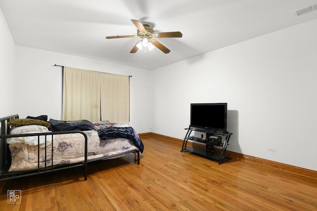 bedroom with light wood-style flooring, ceiling fan, baseboards, and visible vents