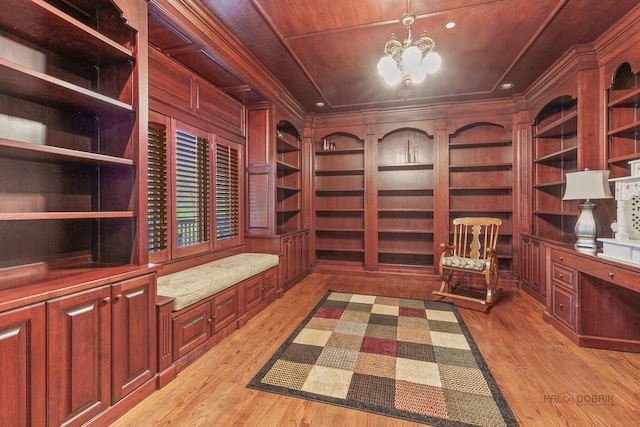 unfurnished room with light wood-style floors, built in shelves, a chandelier, wooden ceiling, and ornamental molding