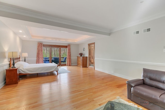 bedroom featuring light wood-style flooring, access to exterior, baseboards, a raised ceiling, and crown molding