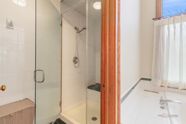 bathroom featuring a shower stall and tile patterned floors