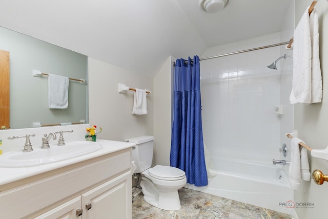 bathroom featuring toilet, vanity, shower / bath combo with shower curtain, and stone finish floors