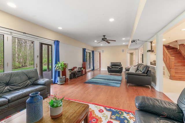 living room with stairs, wood finished floors, recessed lighting, a ceiling fan, and baseboards