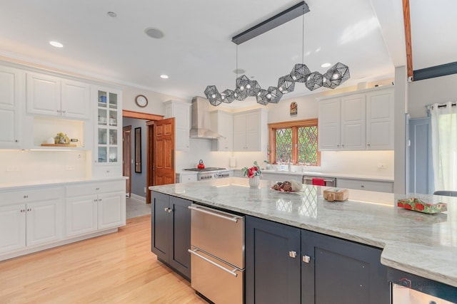 kitchen featuring wall chimney exhaust hood, white cabinets, recessed lighting, and light stone counters