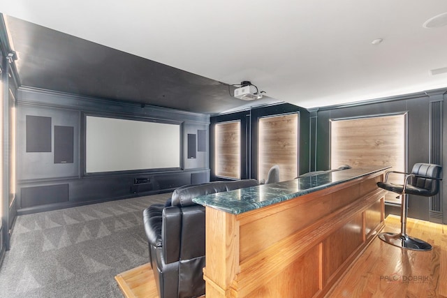 home theater featuring a decorative wall and crown molding