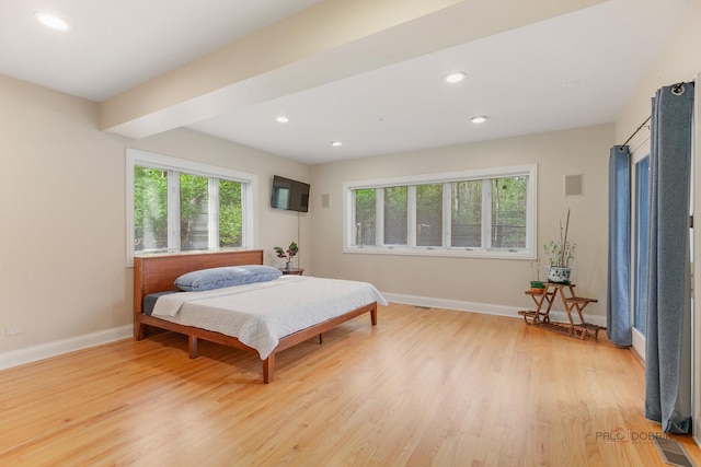 bedroom with light wood-type flooring, baseboards, and recessed lighting