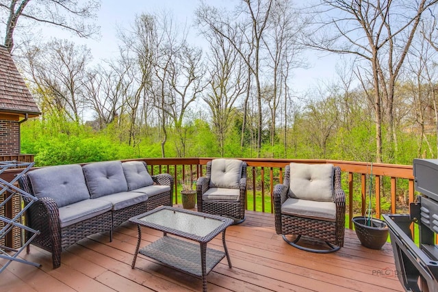 wooden terrace with an outdoor living space