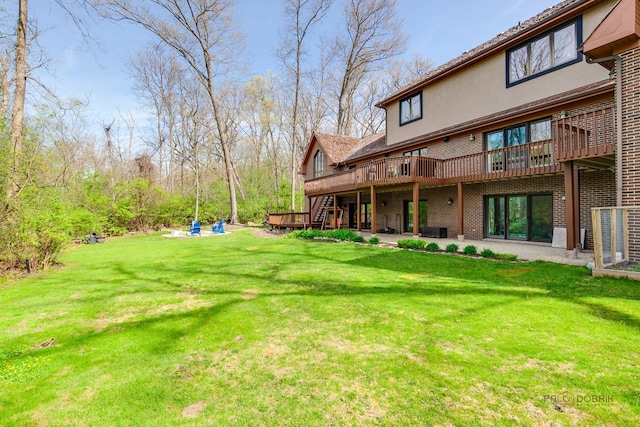 view of green lawn with a deck