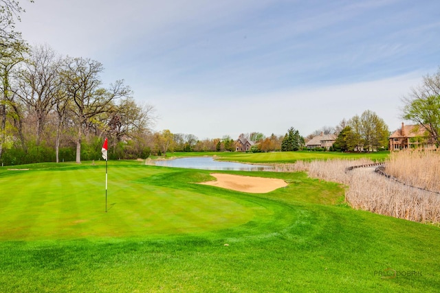 view of property's community featuring a water view, golf course view, and a yard