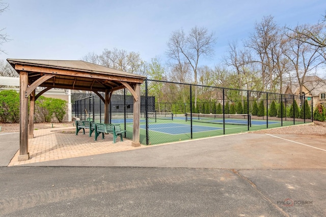 view of home's community with a tennis court, fence, and a gazebo