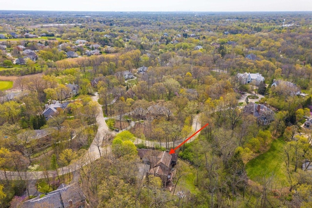 aerial view of property and surrounding area with a forest
