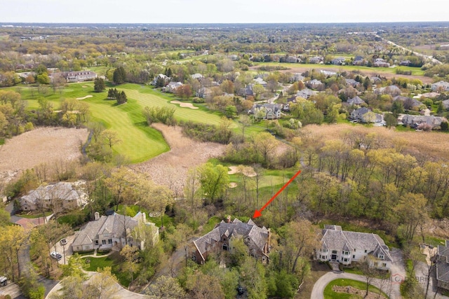 aerial view of property and surrounding area with a golf club and nearby suburban area