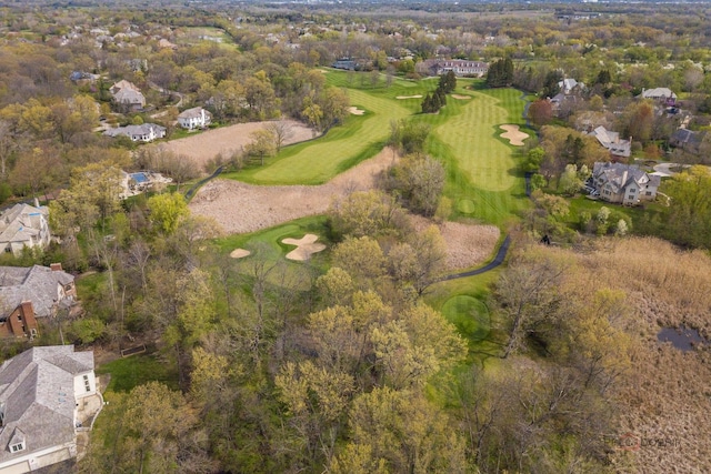 view of property location featuring a local golf course and nearby suburban area