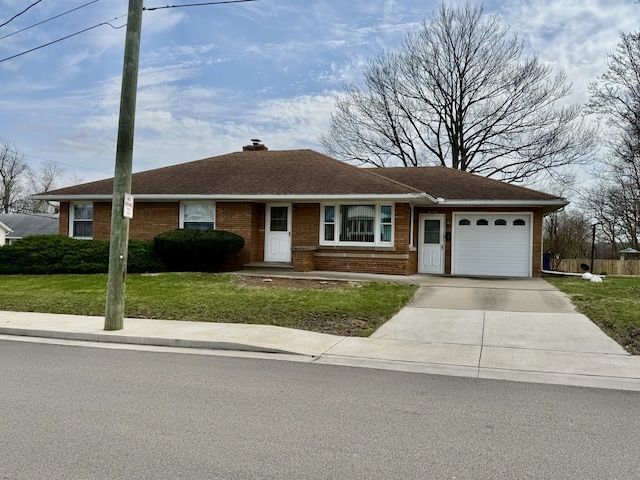 1002 7th St, Peru, IL 61354 - ranch-style home with a garage, a chimney, concrete driveway, brick siding, and a front lawn
