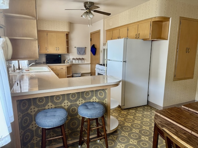 1002 7th St, Peru, IL 61354 - kitchen with white appliances, a ceiling fan, open shelves, a sink, and light countertops