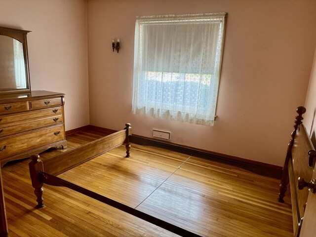1002 7th St, Peru, IL 61354 - bedroom with baseboards and hardwood / wood-style flooring