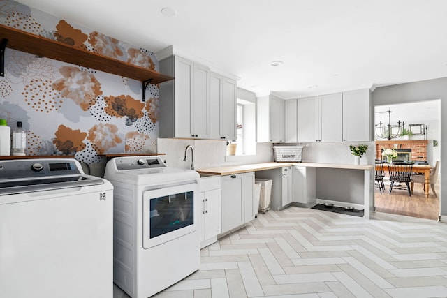 laundry area featuring recessed lighting, a sink, cabinet space, and washing machine and clothes dryer
