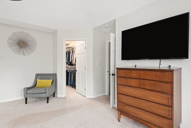 sitting room featuring baseboards and light carpet