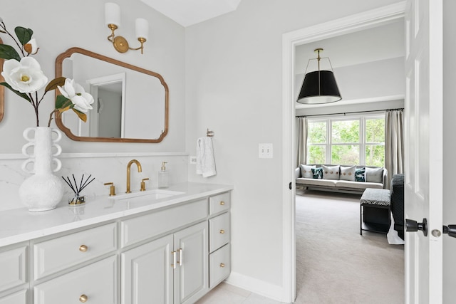 ensuite bathroom with vanity, ensuite bathroom, and baseboards