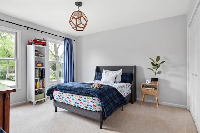 bedroom featuring baseboards and carpet