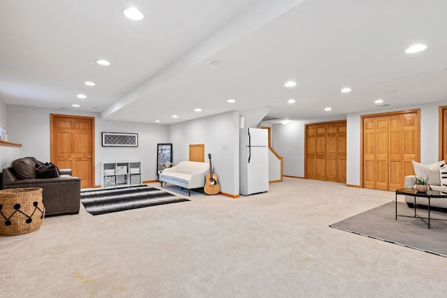 living room featuring recessed lighting, baseboards, and light colored carpet