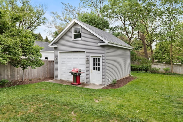 view of outbuilding featuring fence and an outbuilding