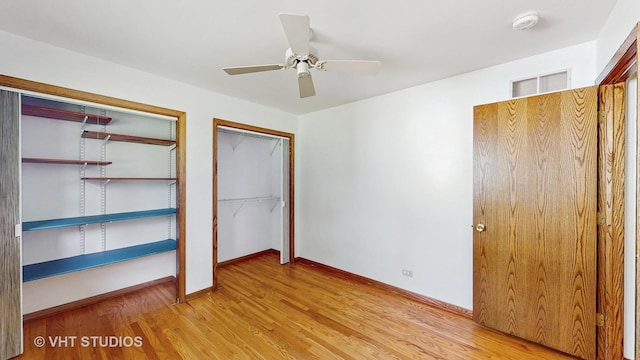 1144 Jane Ave, Naperville, IL 60540 - unfurnished bedroom with light wood-type flooring, two closets, and a ceiling fan