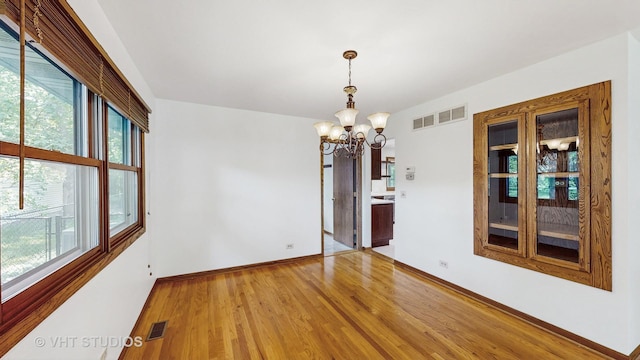 1144 Jane Ave, Naperville, IL 60540 - empty room featuring a chandelier and light wood-type flooring