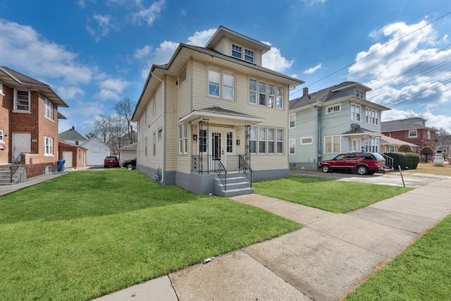 123 Philippa Ave, Waukegan, IL 60085 - american foursquare style home featuring a residential view, a front lawn, and an outbuilding